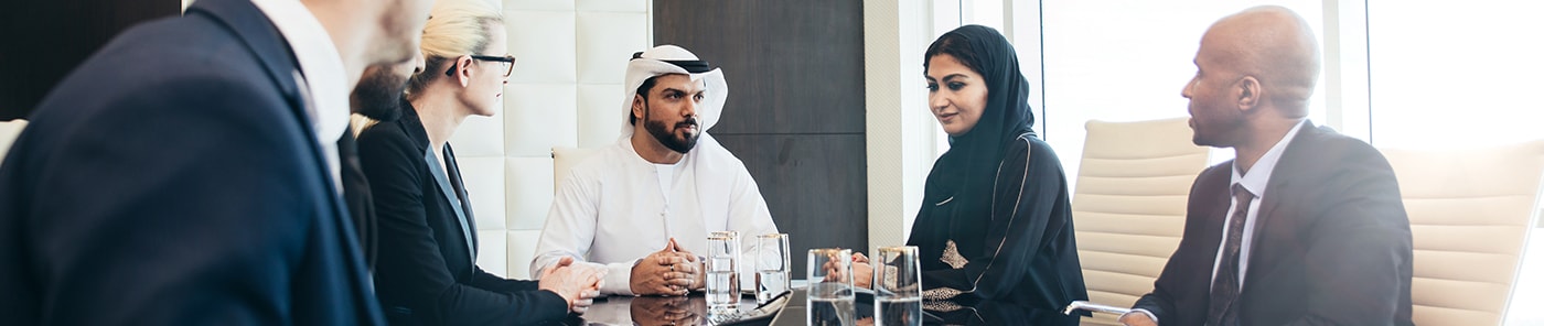Senior executives in discussion around a boardroom table