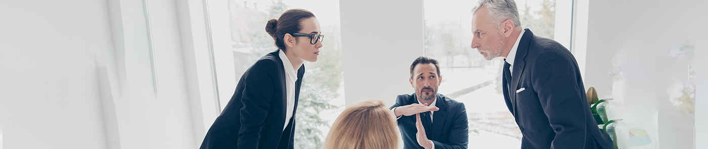 Tense discussion between colleagues in a meeting room