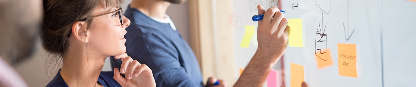 Team mapping ideas with sticky notes on a whiteboard
