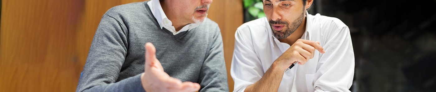 Experienced coach talking with a younger colleague