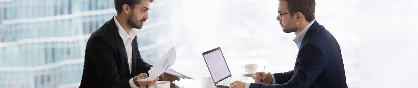 Interviewer and candidate facing each other across a desk