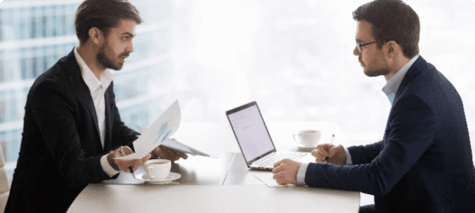 Interviewer and candidate facing each other across a desk