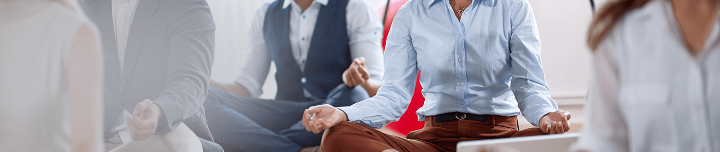 Colleagues meditating together in an office