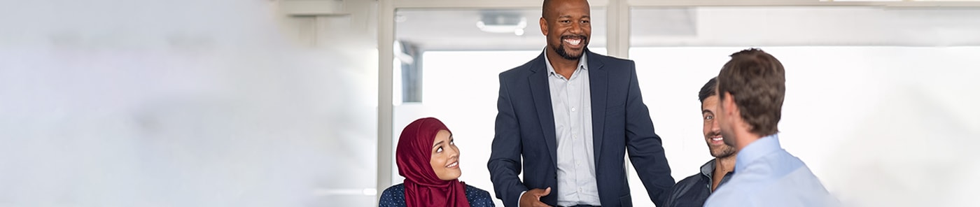 Colleagues sharing a relaxed conversation in a meeting